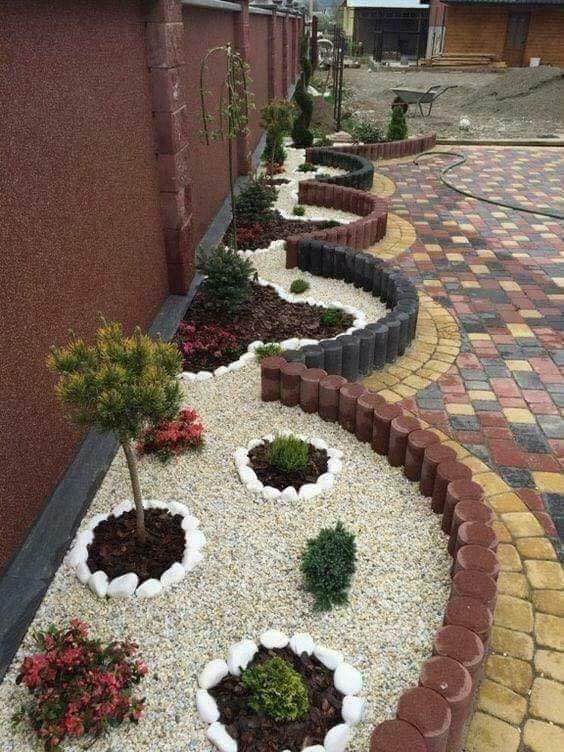 Curved rock, edging, and paver design by Green Horse