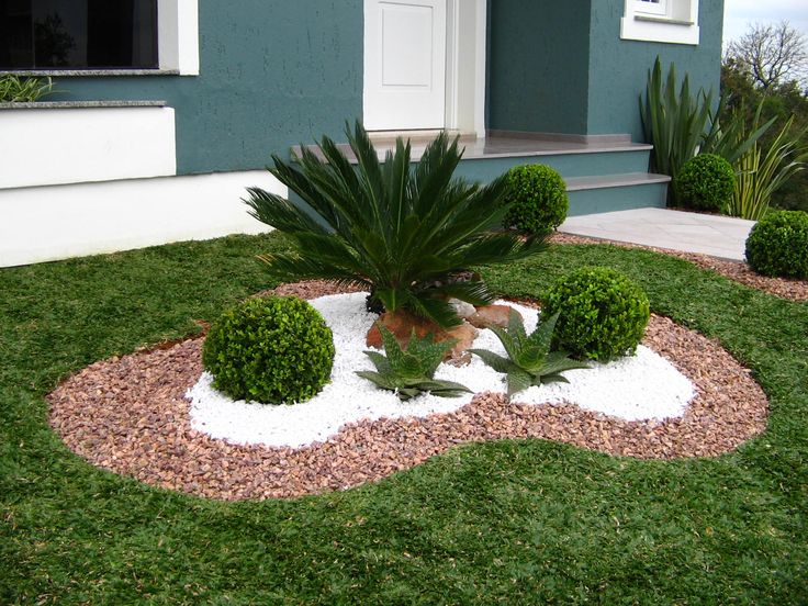 Decorative rock and manicured shrub layout by Green Horse