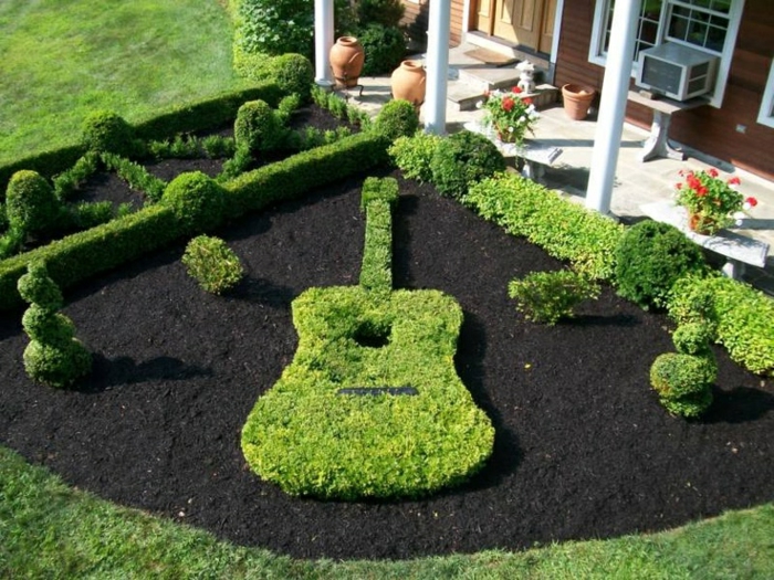 Custom hedge and guitar-shaped landscape feature by Green Horse